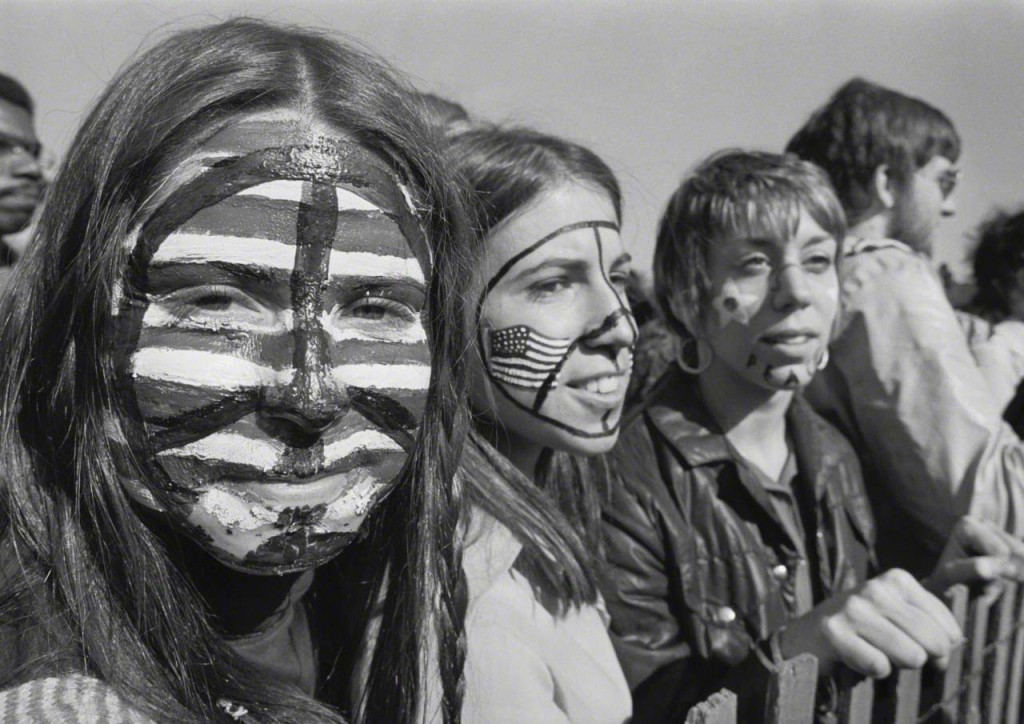 15 Apr 1970, Boston, Massachusetts, USA --- Three young women, their faces painted with American flags and peace signs, take part in a large anti-war demonstration on Boston Common, which drew almost 100,000 people, against the war in Vietnam, on April 15, 1970. --- Image by © Bettmann/CORBIS