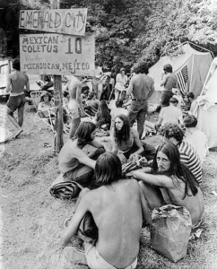 FILE - In this Aug. 1, 1970, file photo, youths sell marijuana openly from sacks at a banned music festival in Middlefield, Conn. beneath a sign advertising their products as "Mexican Coletus at $10 an ounce."As the conformity of the postwar era took hold, getting high on marijuana and other drugs emerged as a symbol of the counterculture, with Jack Kerouac and the rest of the Beat Generation singing pot's praises. On the occasion of Legalization Day, Thursday, Dec. 6, 2012, when Washingtons new law takes effect, AP takes a look back at the cultural and legal status of the evil weed in American history. (AP Photo/File)